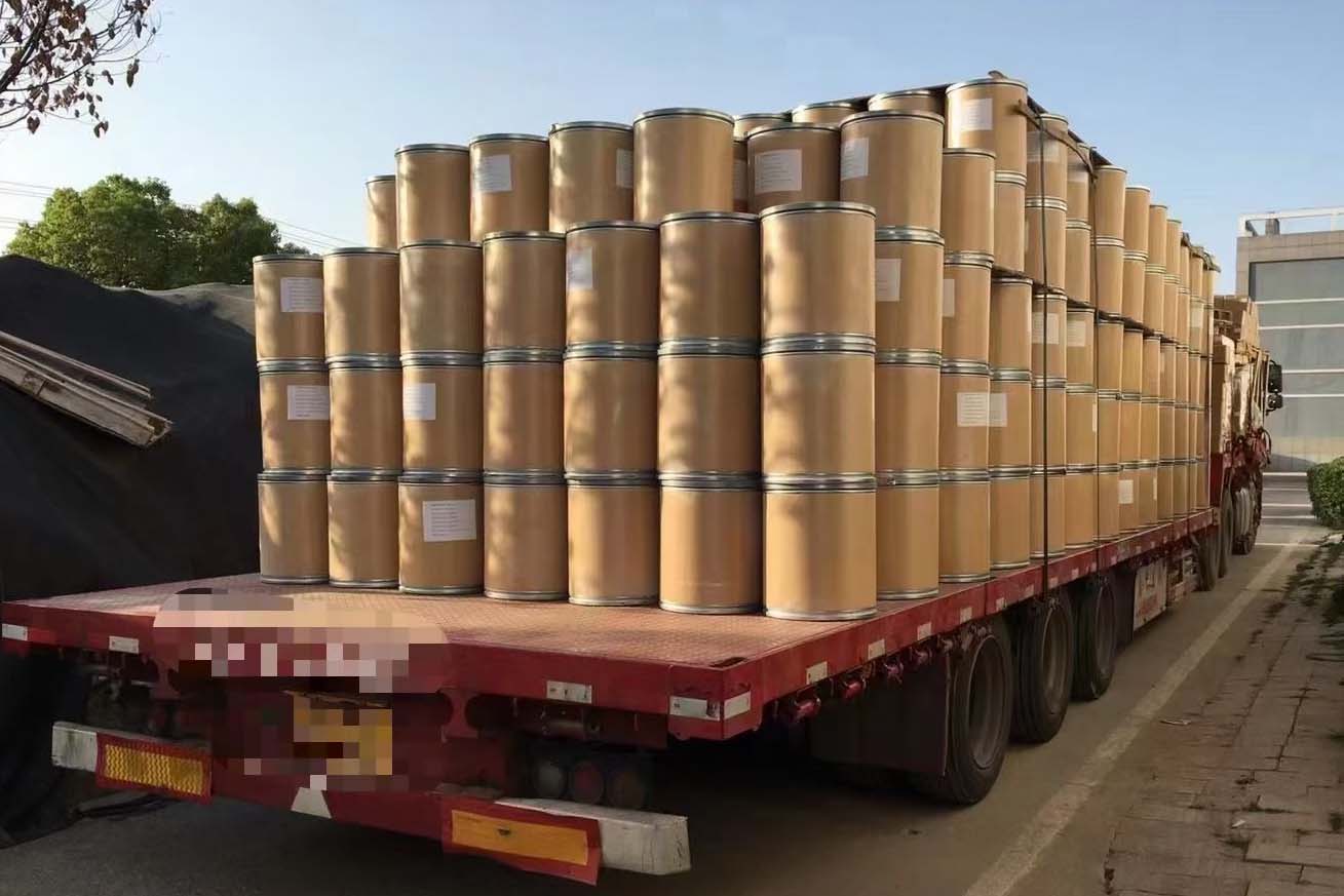 lots of paper barrels of pigments on a truck